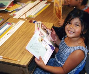 grin-girl-w-book grin-girl-w-book